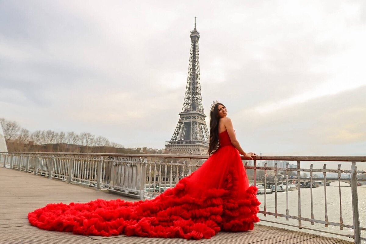 women having a portrait photoshoot in paris wearing a red dress in front of the eiffel tower