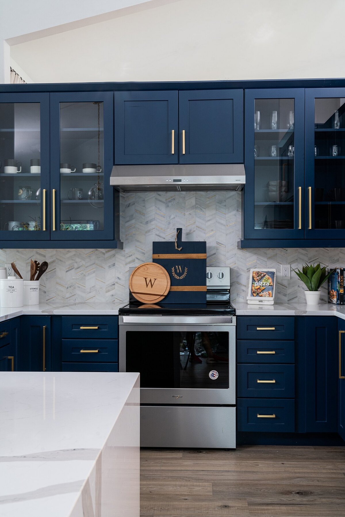 coastal luxury home navy blue and brass kitchen full service interior design by Island Home Interiors Lake Nona 2