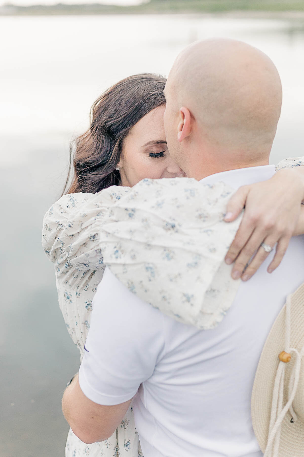 Close-up of a mother holding onto husband's shoulders during a Kansas City family milestone session.