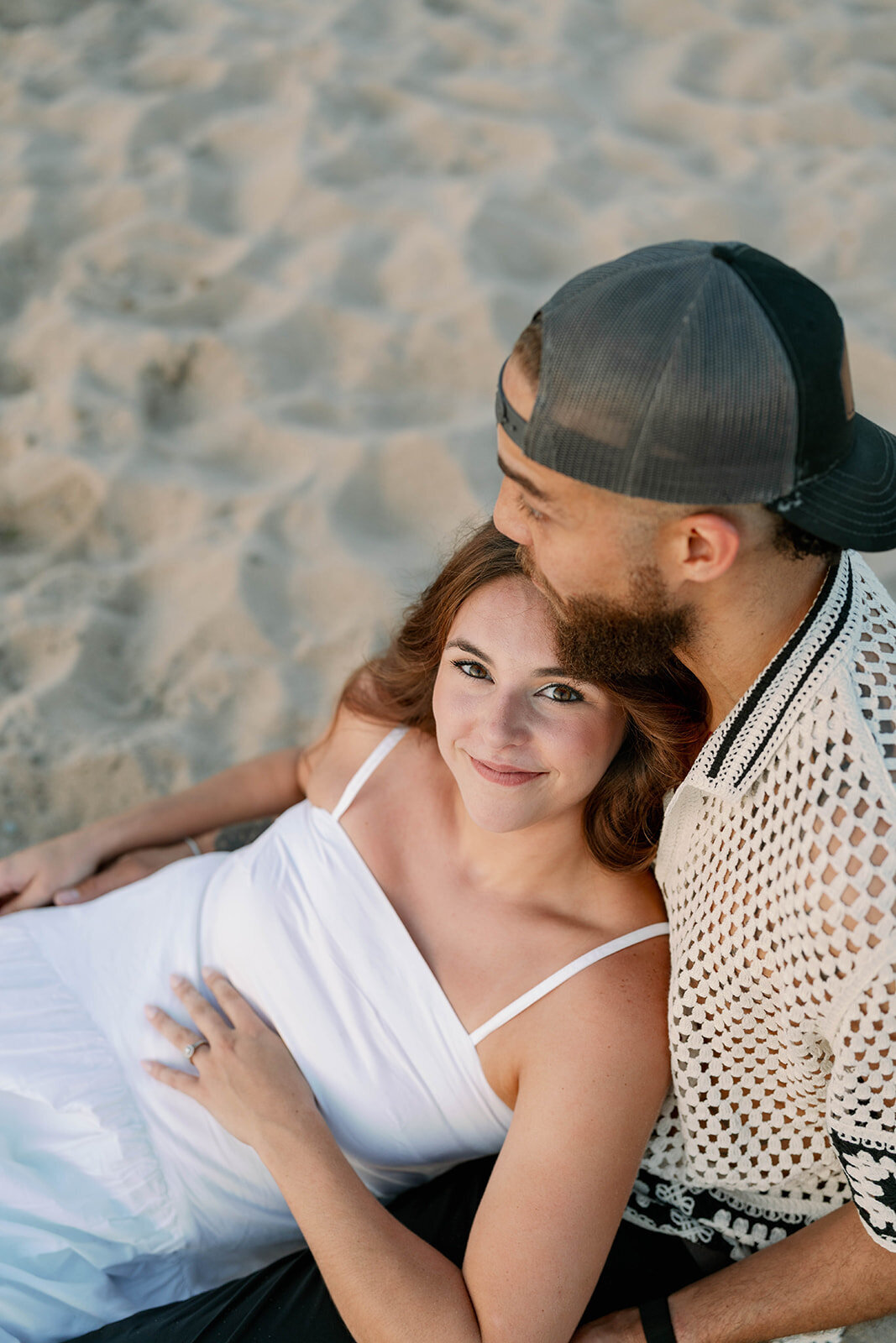 Close-up of couple holding hands during sunset beach engagement photos on Lake Michigan”