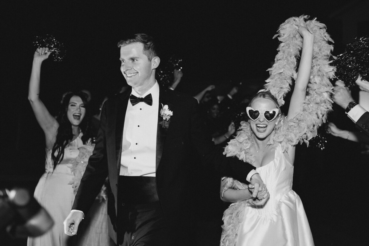 Bride and groom leave wedding reception with cheers