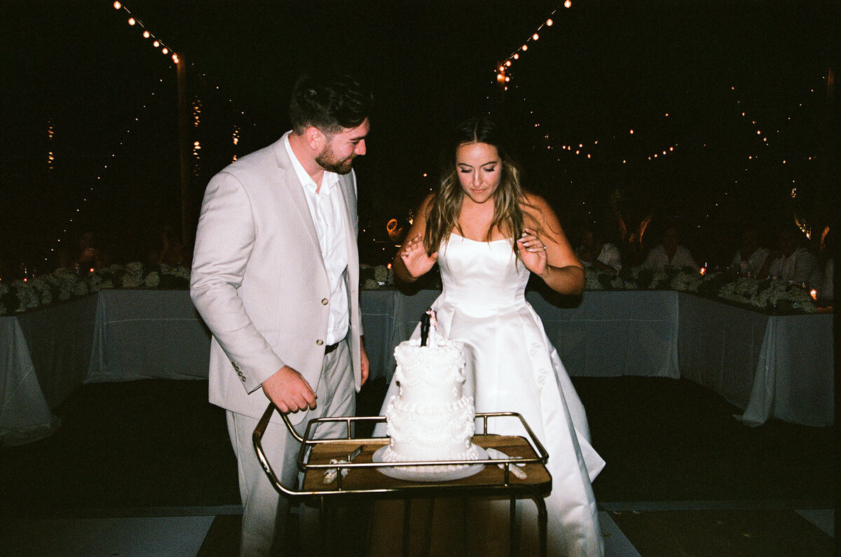 bride and groom cake cutting 35mmfilm cache estate wedding