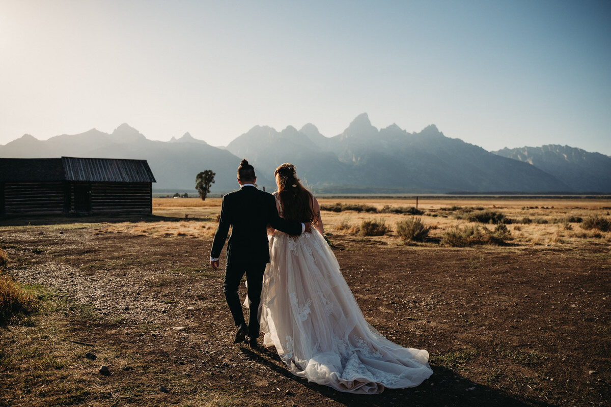 Eloped couple walk at Mormon Row