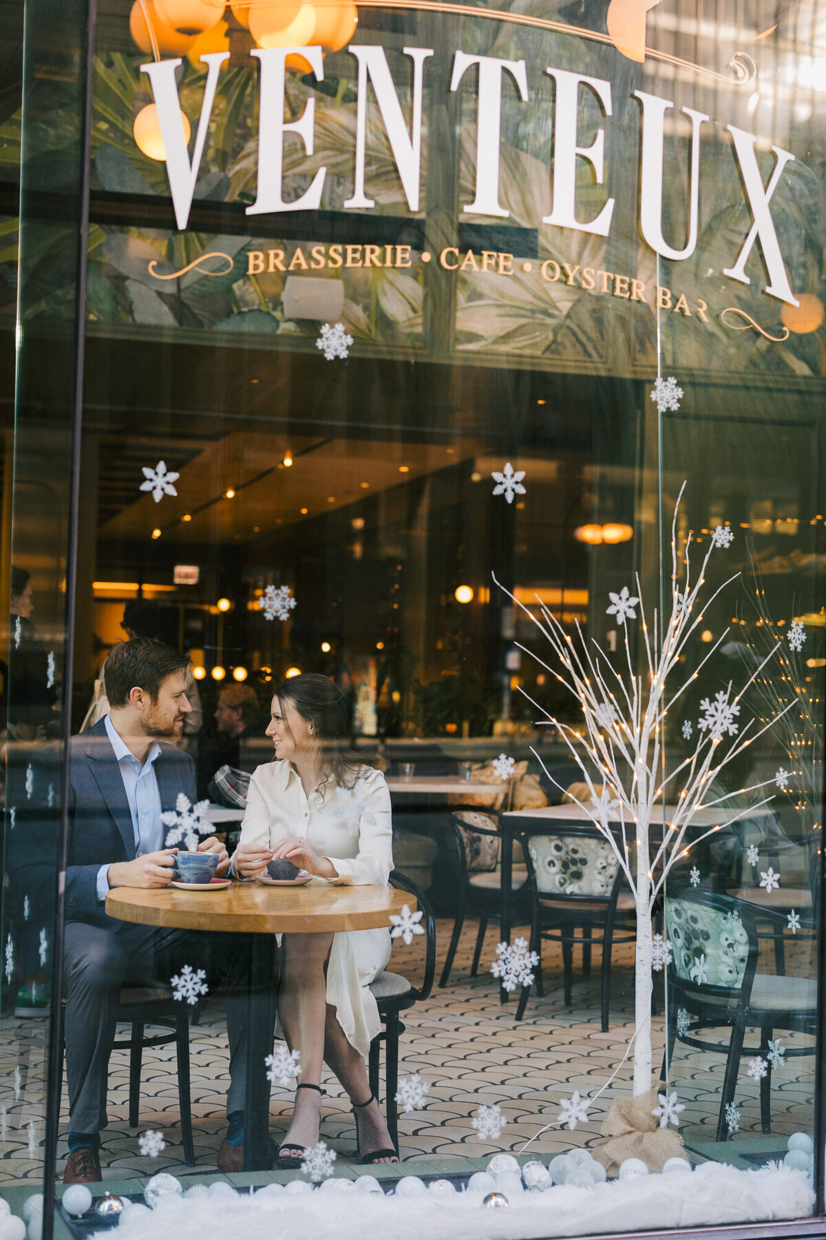 Chicago engagement photographer, Ashley Biess, captures a couple through a window while sitting in a cafe