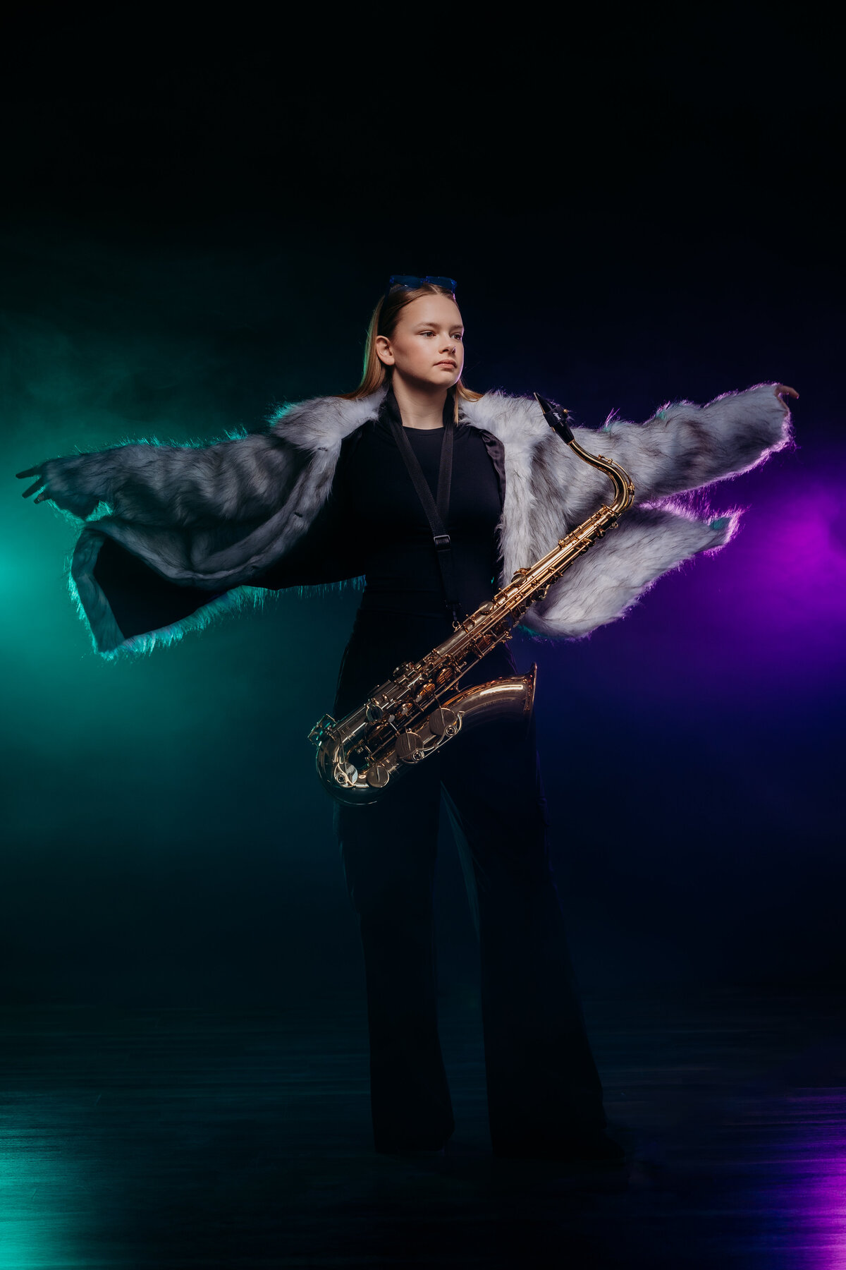 Ionia teen tenor saxophone player flaring jacket for photo.