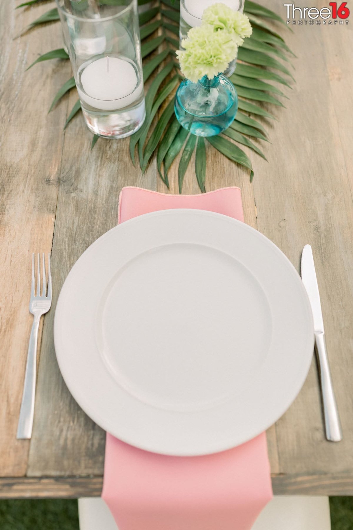 Place setting with pink napkins for wedding reception