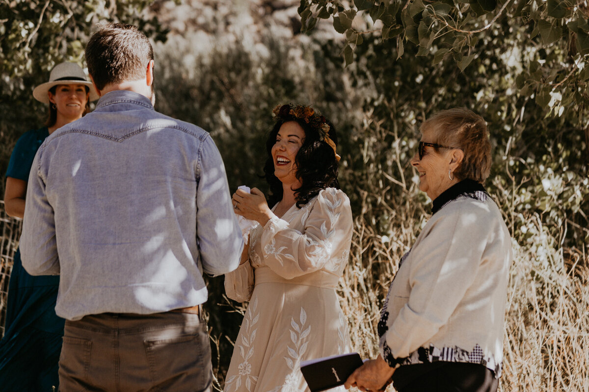 bride laughing during their wedding ceremony