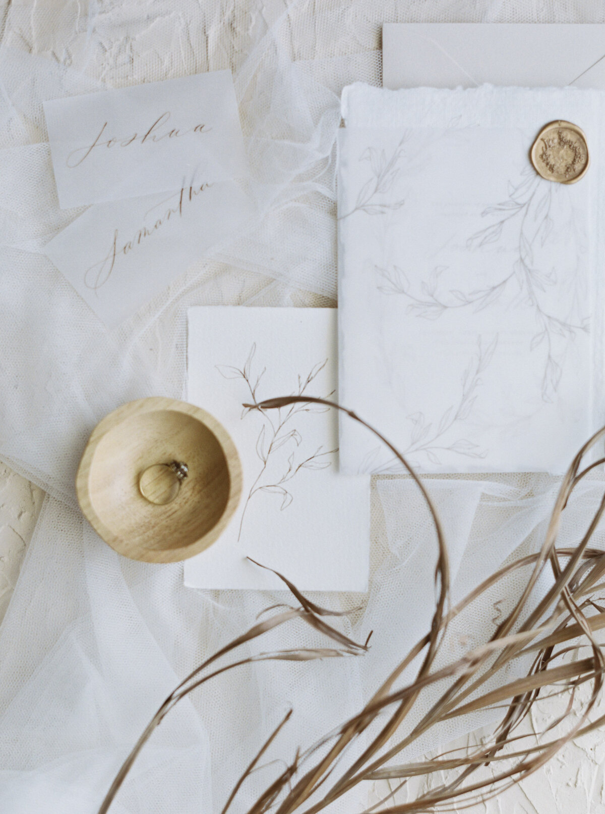 Paper and Ring in small wooden bowl flatlay