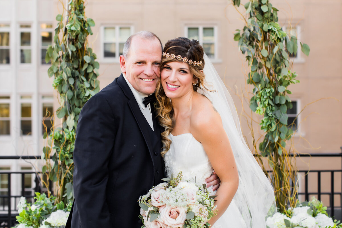 bride and dad smiling for wedding photo