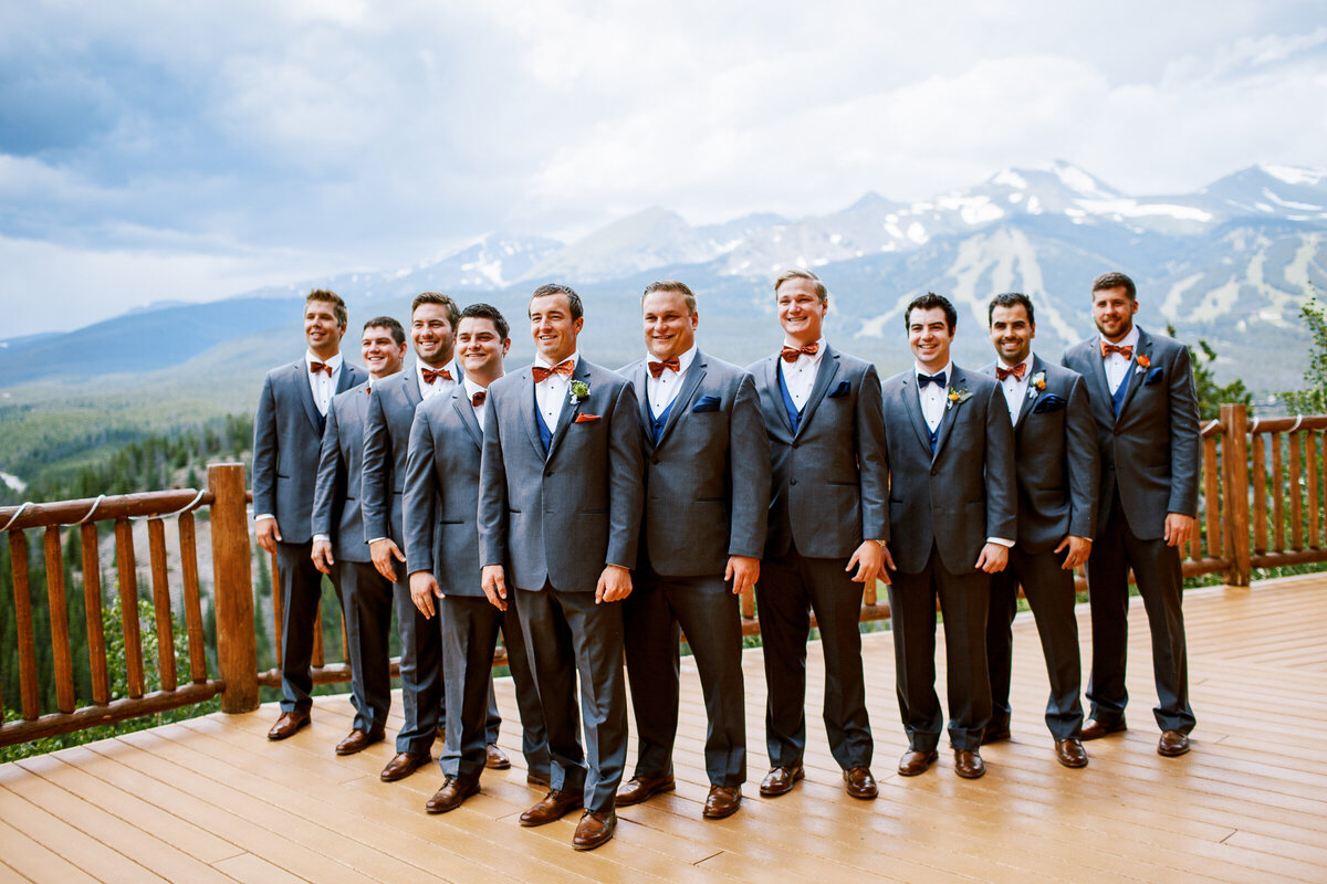 Groomsmen line up on a deck at the Lodge at Breckenridge
