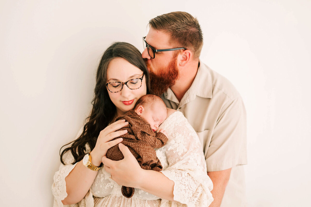 newborn sleeping on parents shoulder during Springfield MO newborn photography session