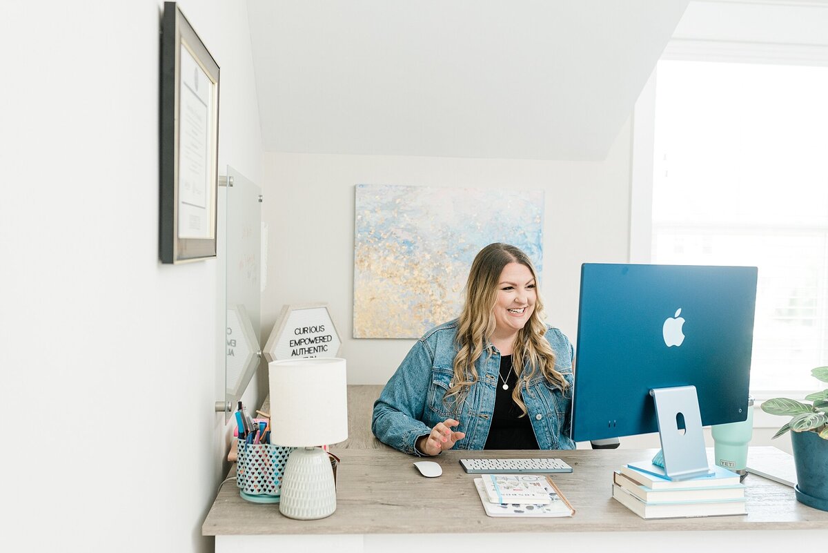 Emily Conley of Emily Writes Well who is a Creative Copywriter for small business owners poses for her branding photos with Dolly DeLong Photography