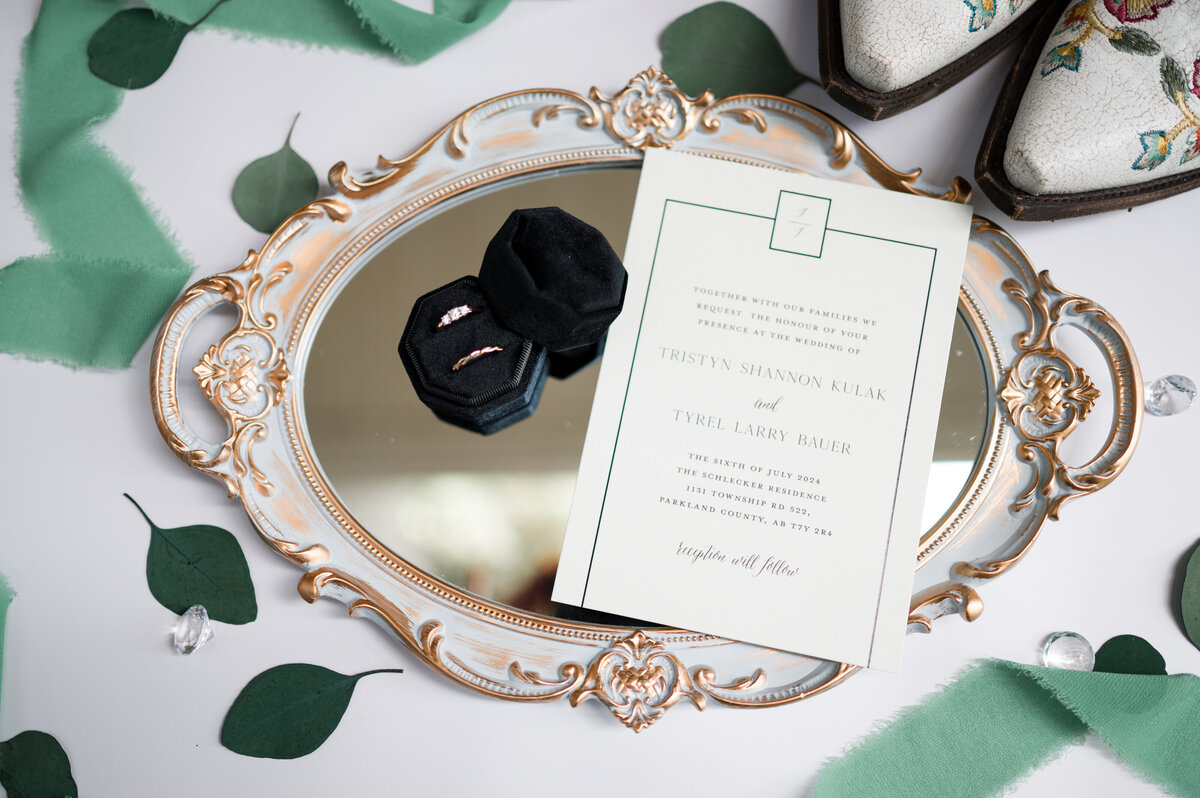 photo of wedding rings on a mirror artistically organized