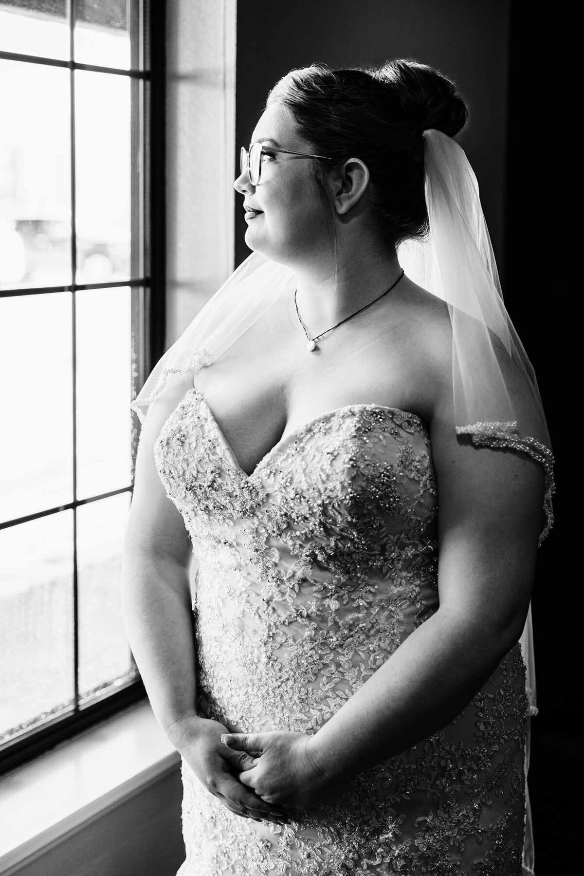 Black and white portrait of bride looking out window, Broadway River Inn, Hamilton