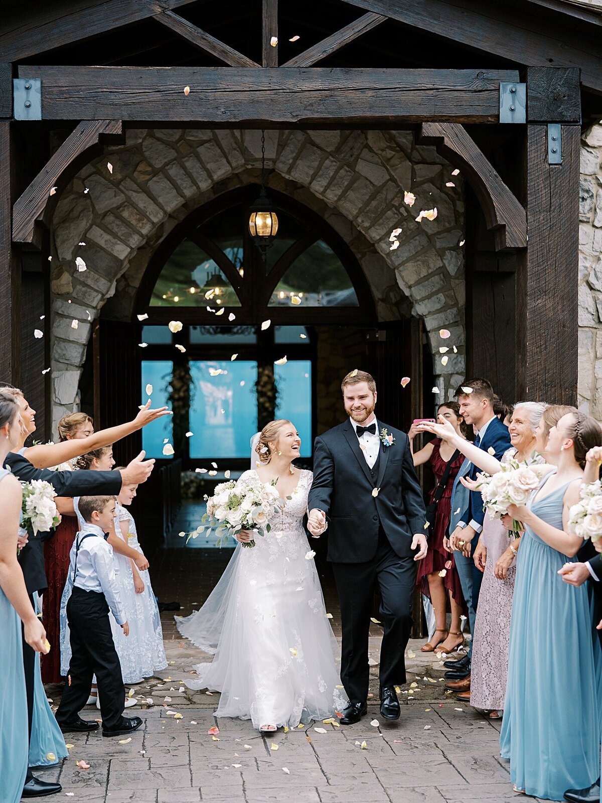 wedding-bride-groom-newlyweds-mountains-petals