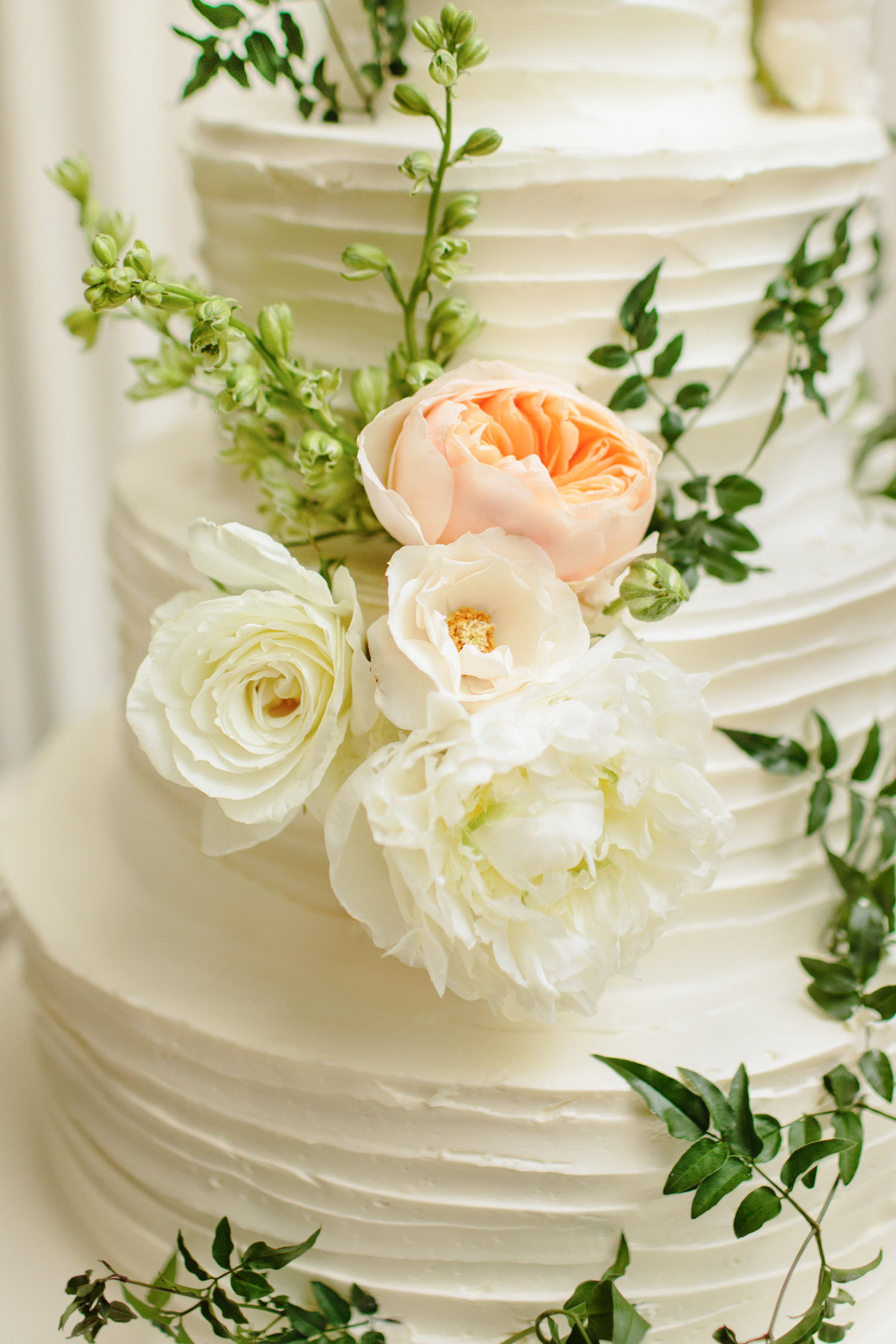 Amy Osaba florals bring the perfect touch of softness to this wedding cake.  Photo by Rebecca Cerasani.
