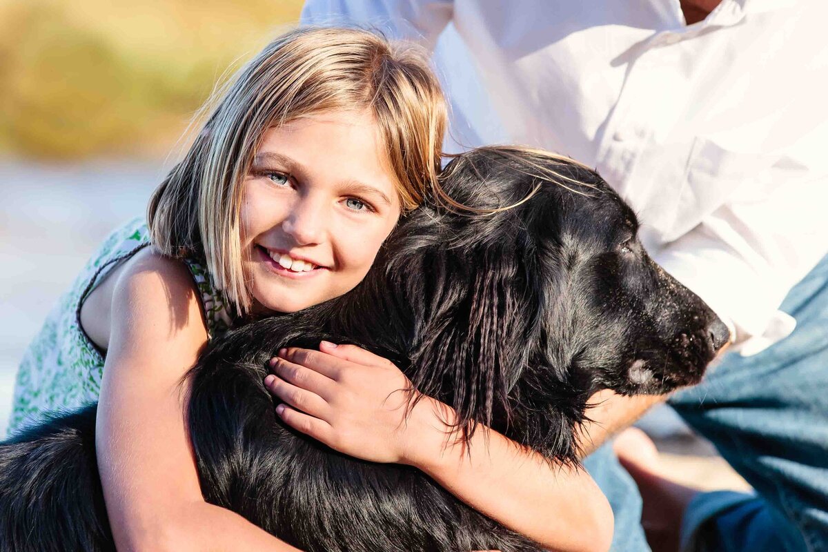 girl-hugs-dog-point-reyes-beach