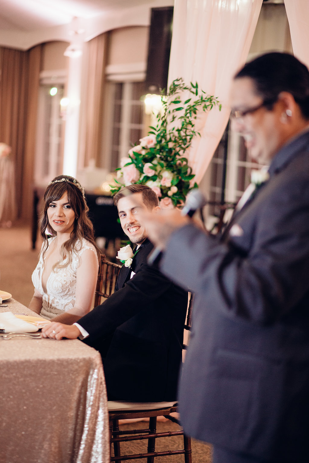 Wedding Photograph Of Bride And Groom Laughing At The Man Speaking In The Microphone Los Angeles