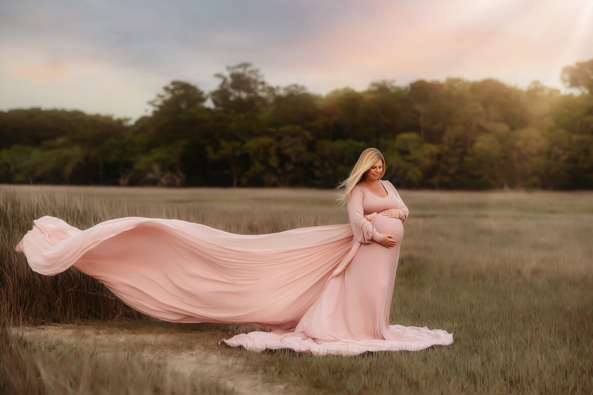 Pregnant woman poses for Maternity Portraits in the march in Charleston, SC.