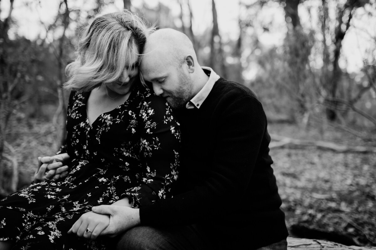 black and white image of couple holding hands sitting outside. Couples and engagement photography Melbourne, And So I Don’t Forget Photography