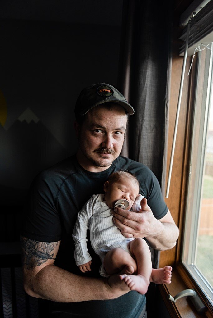 dad holding newborn boy