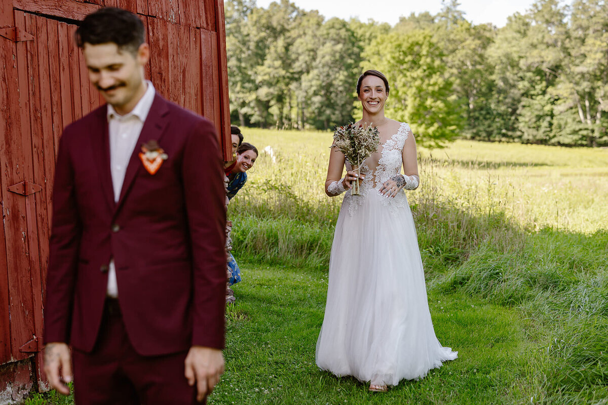 A person walking up towards their partner for their first look