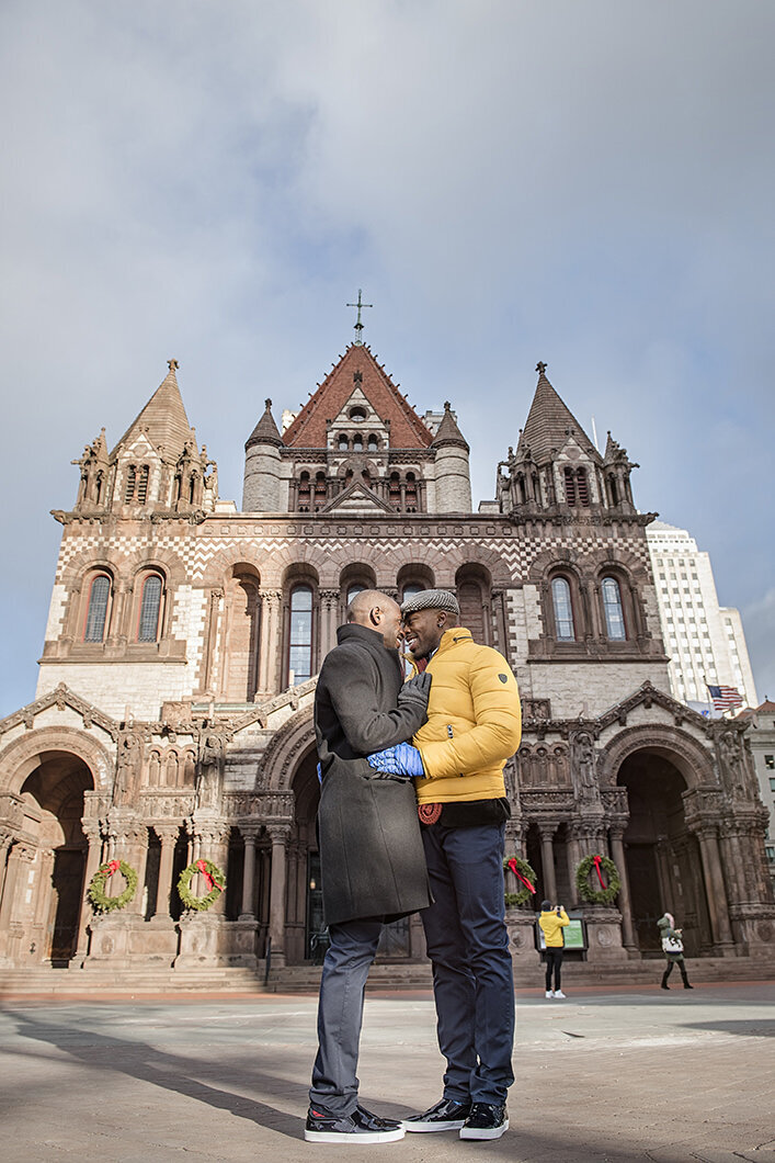 A couple about to kiss in front of a church