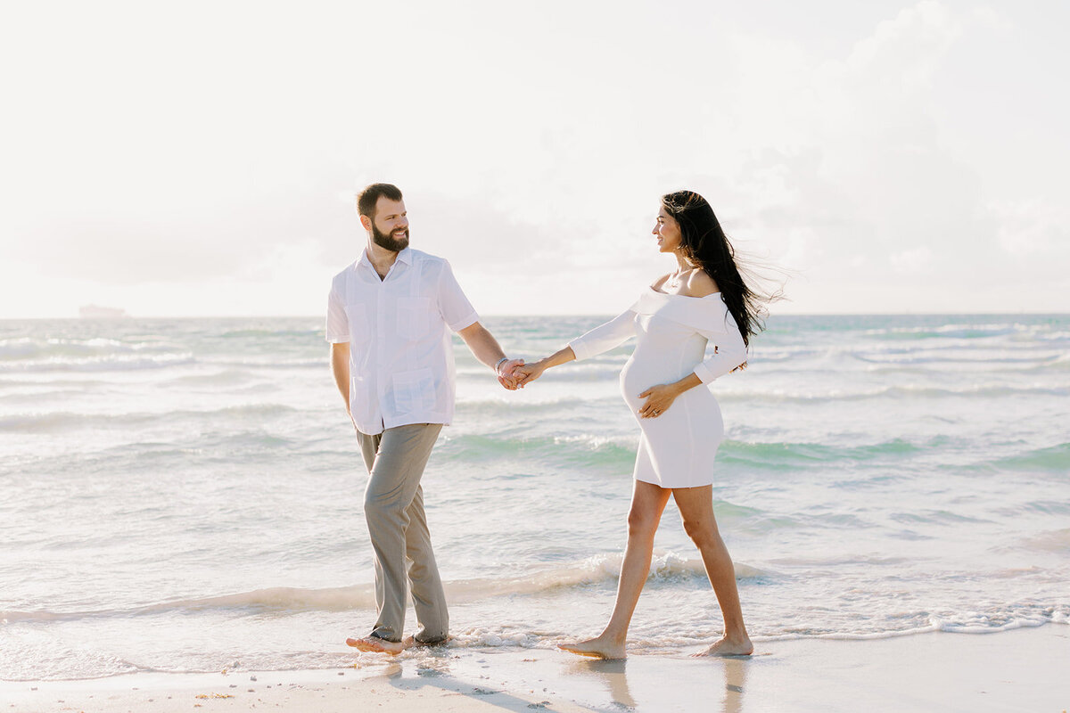 A candid moment of love and anticipation captured on a Florida beach.