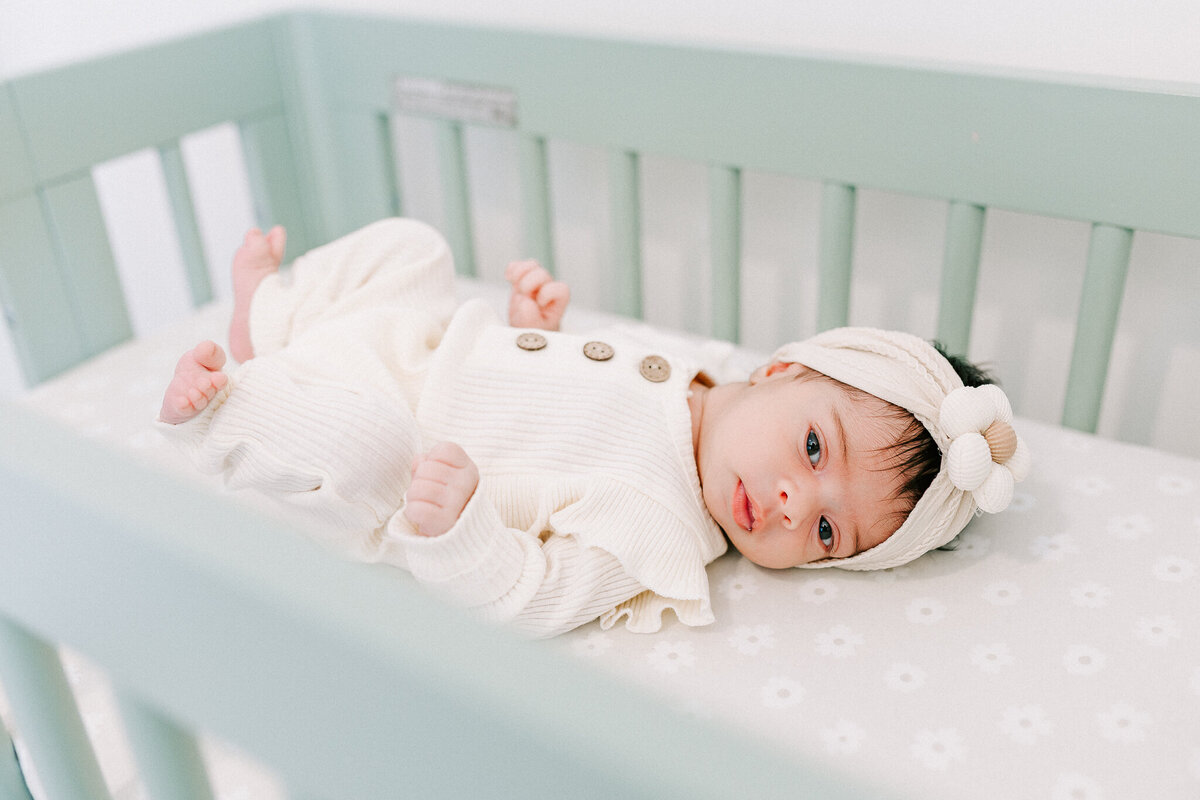 Newborn resting peacefully in a soft, neutral-toned nursery – captured by a Birmingham newborn photographer. 