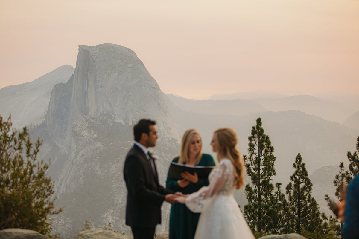 Couple holding hands during their sunrise elopement ceremony at Yosemite
