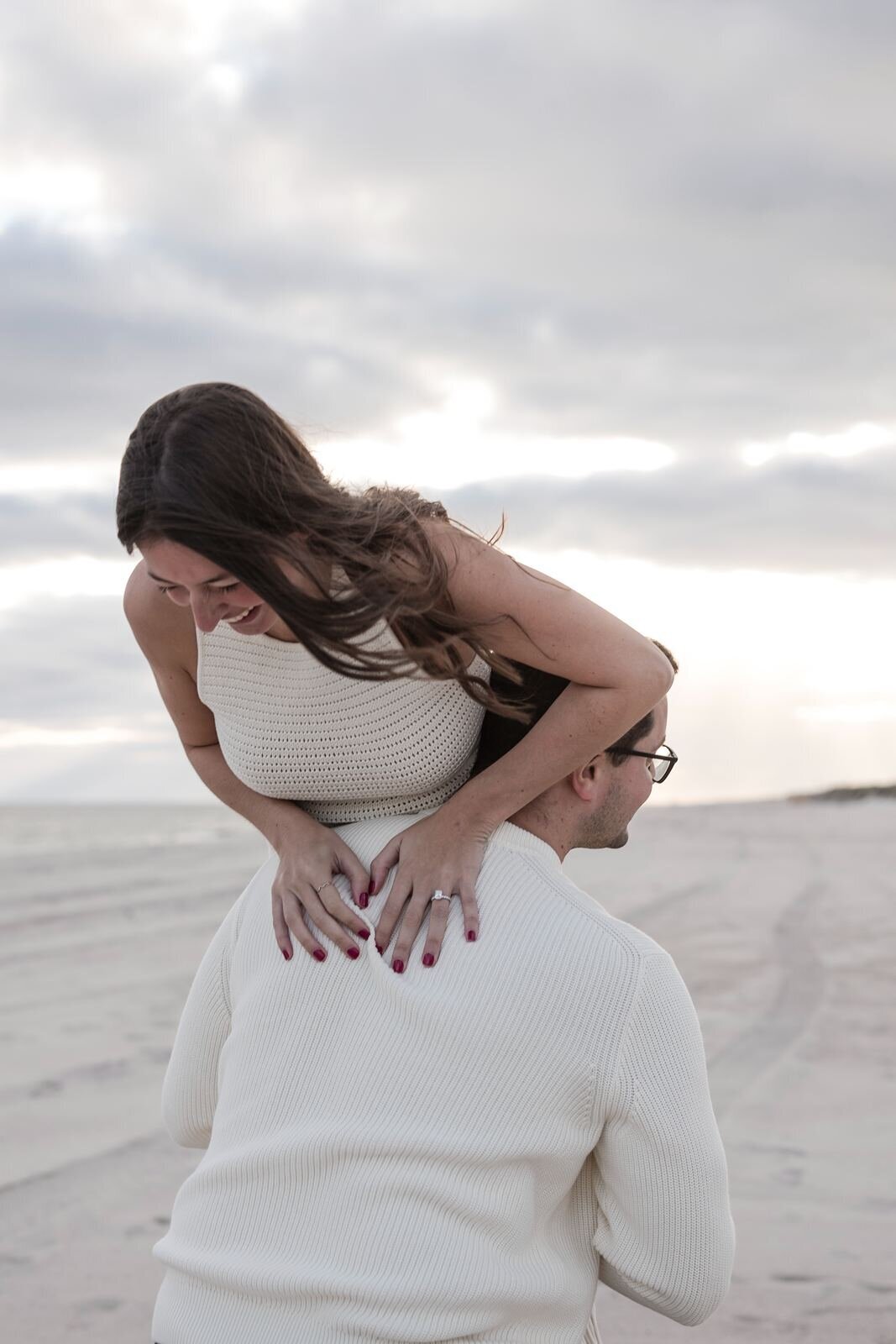 Young woman beign lifted by fiance.