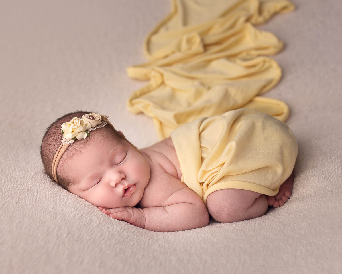 Bums up newborn in yellow at Cleveland Newborn Photography studio.