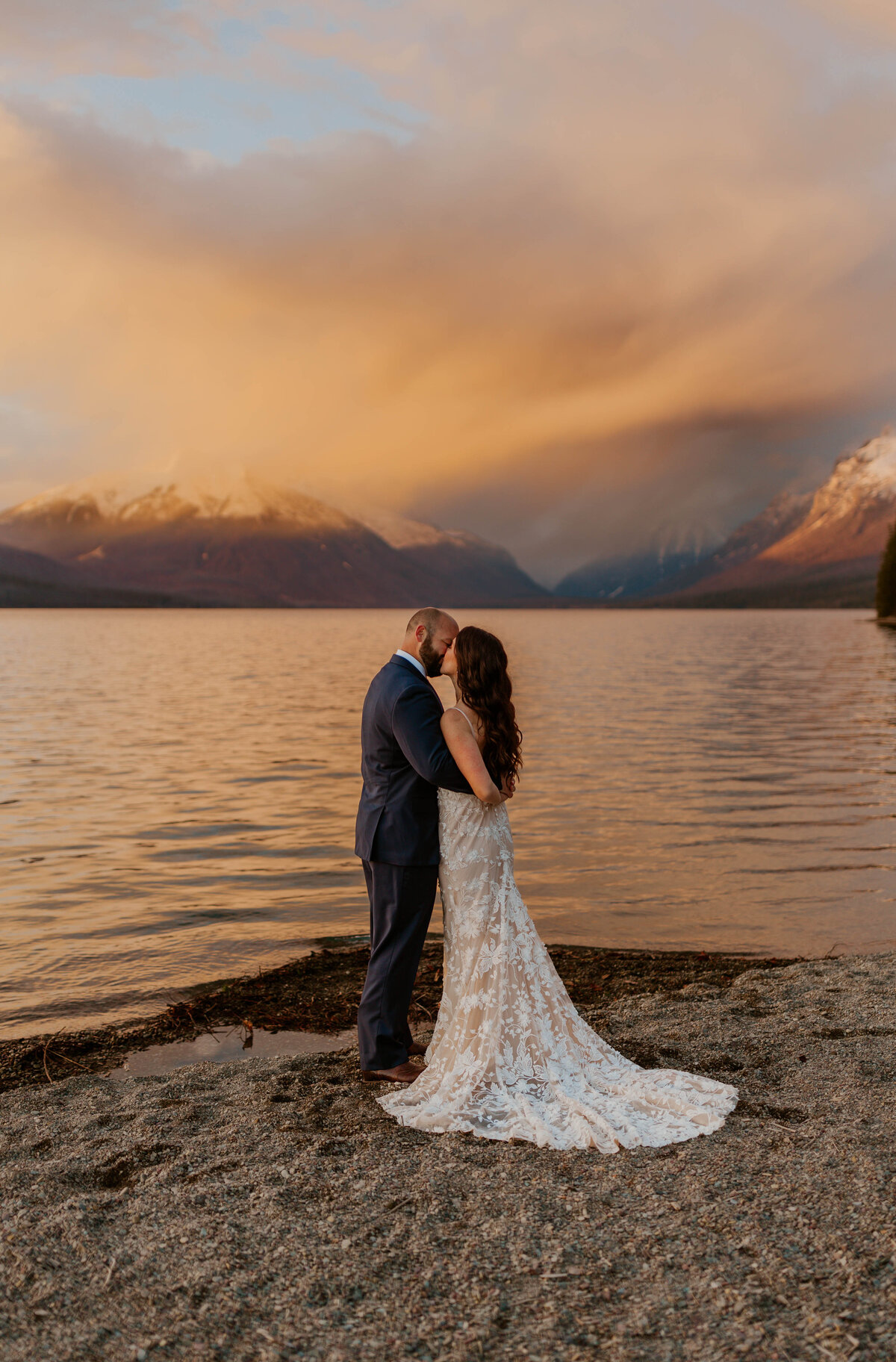 bride and groom kissing on beach