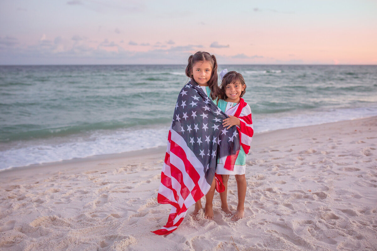 sisters-wrapped-in-american-flag-scarf-on-beach