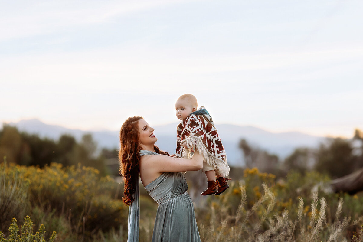 mom and baby against a beautiful mountain backdrop in loveland colorado
