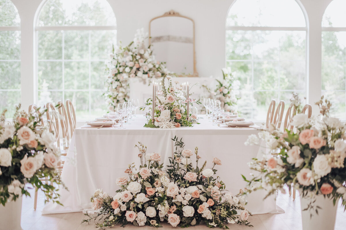 Gorgeous tablescape with white and pink by Calyx Floral Design, an innovative Red Deer, Alberta wedding florist, featured on the Brontë Bride Vendor Guide.
