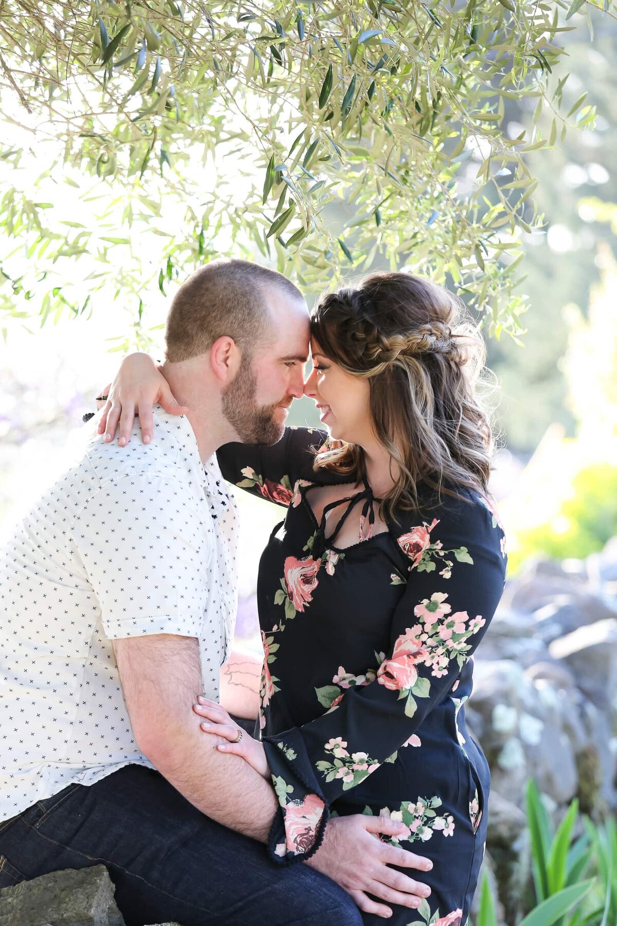 engagement photographer Wake Forest, NC. Engaged couple hugging and touching foreheads. Romantic moment between bride and goorm to be.