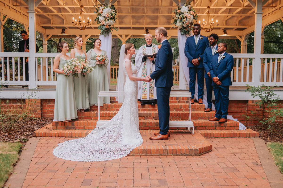 Two people get married surrounded by loved ones