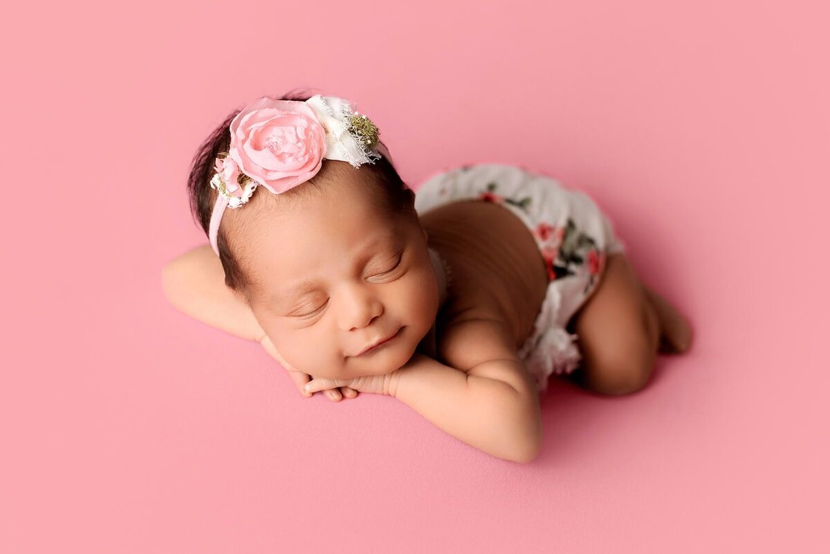 mobile-in-home-newborn-photography-vancouver-fraser-valley_baby-girl-pink-smiling-flower-outfit