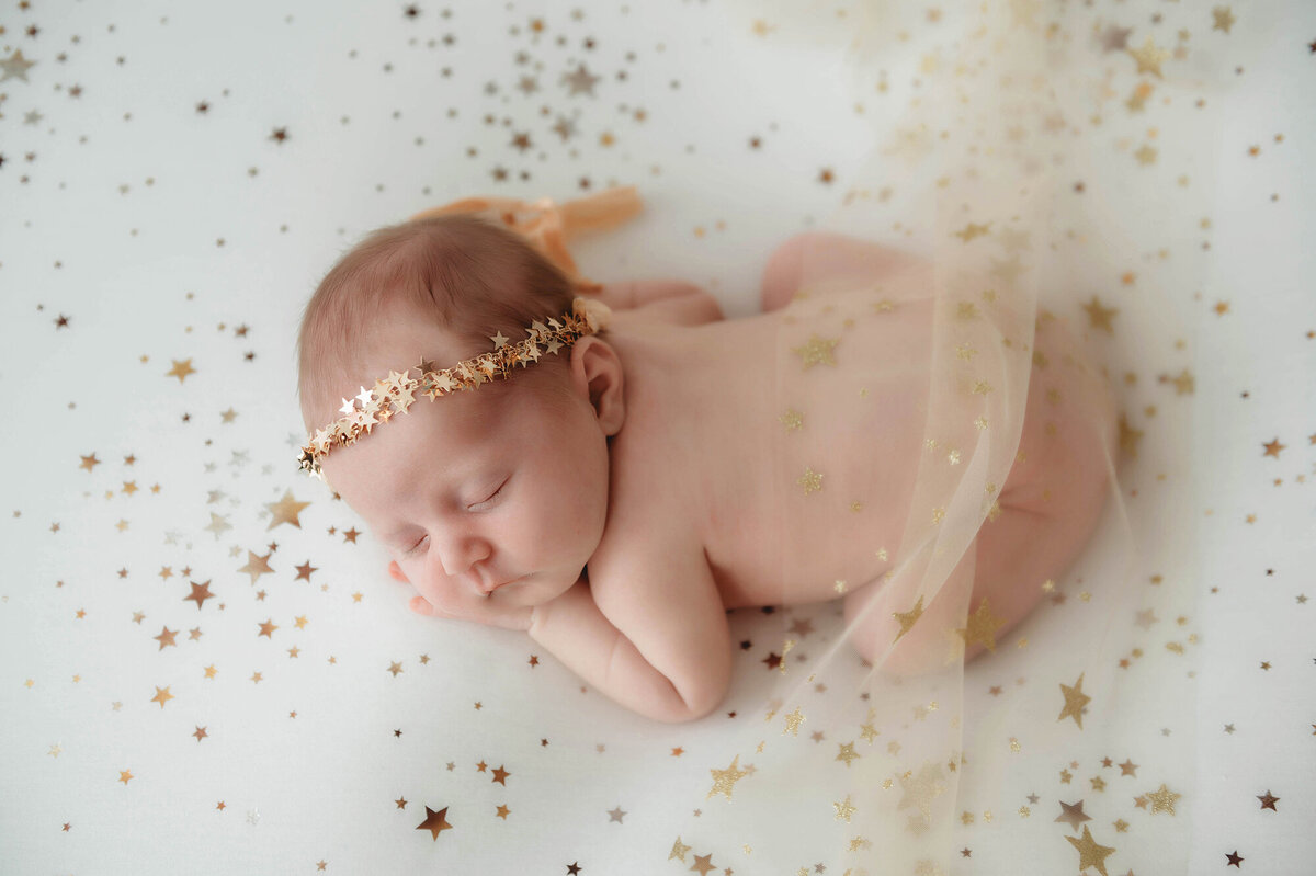 Best Baby Photographer in Charleston, SC poses Infant for Newborn Photoshoot.