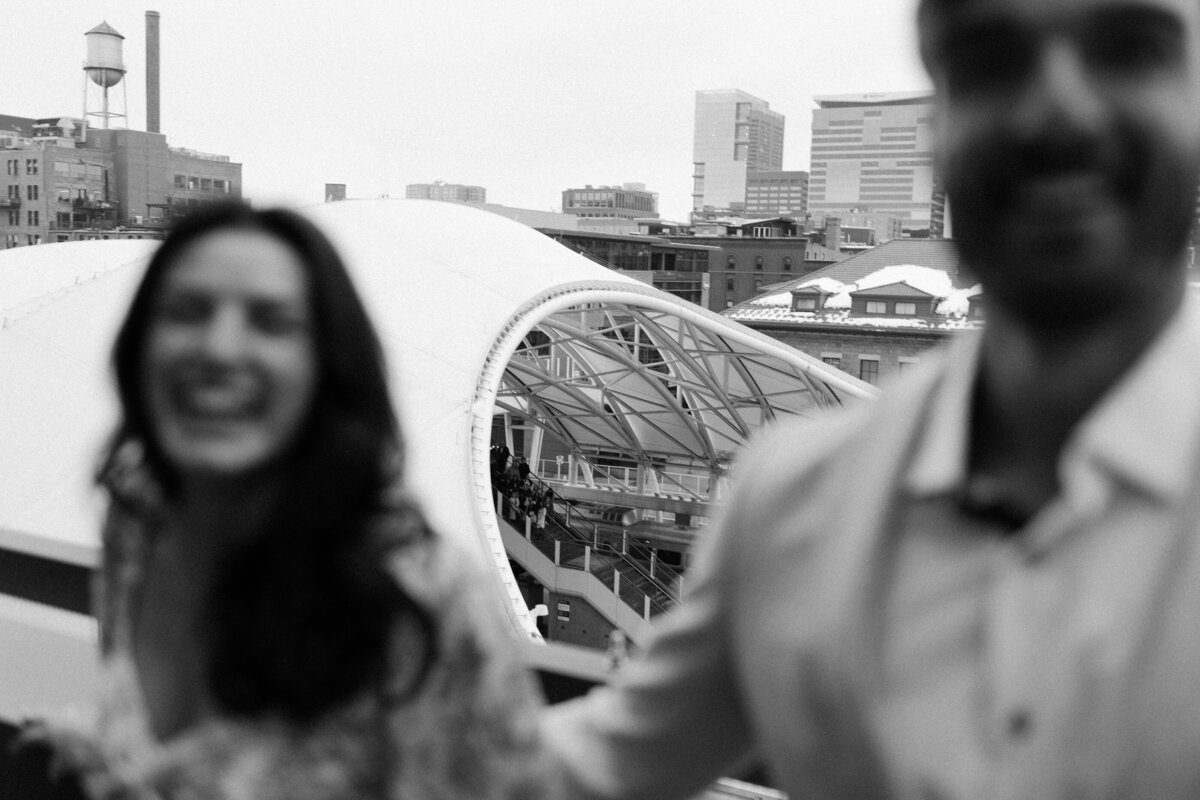 Newly engaged couple celebrates their engagement after a hidden photographer documented their proposal in downtown Minneapolis.