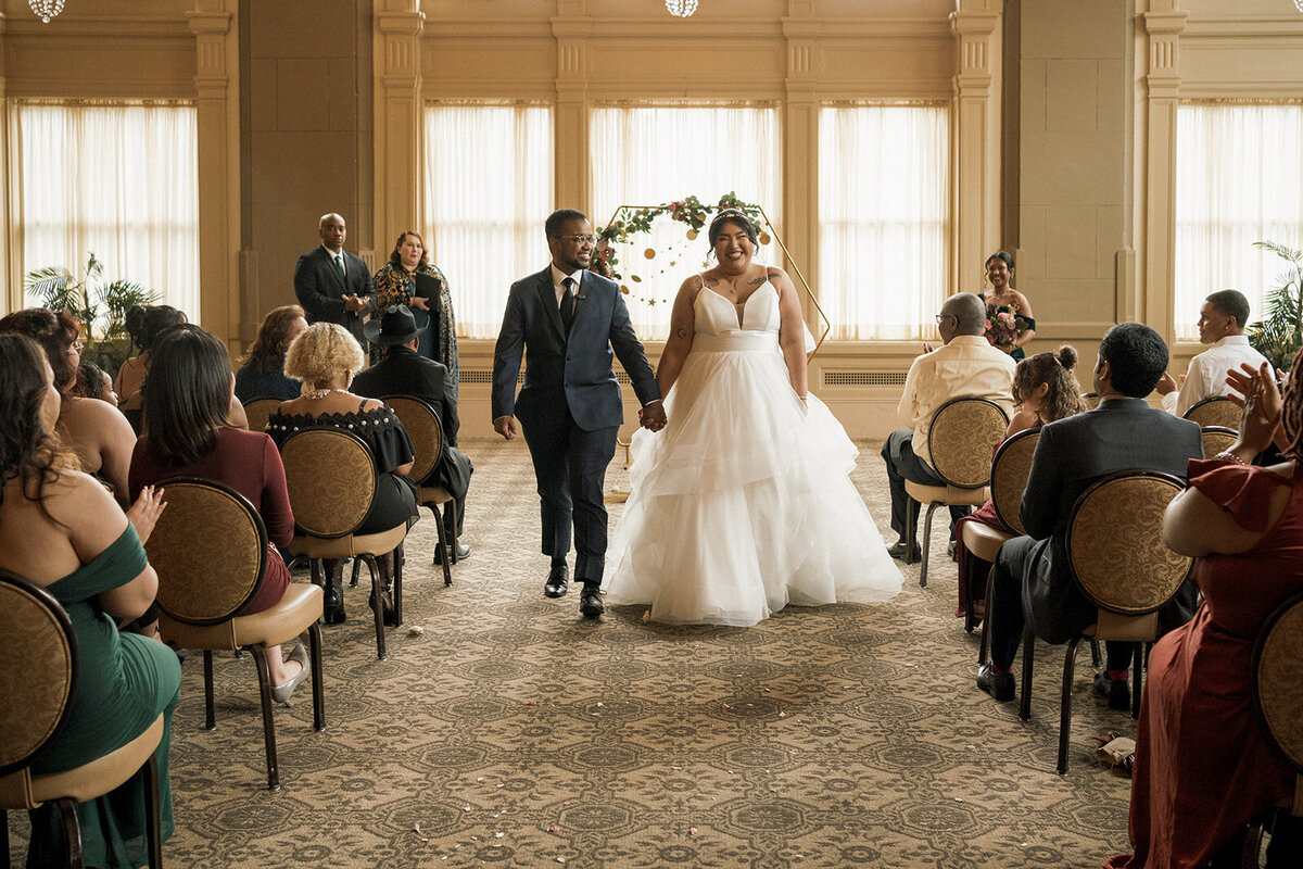 happy couple walking down the aisle