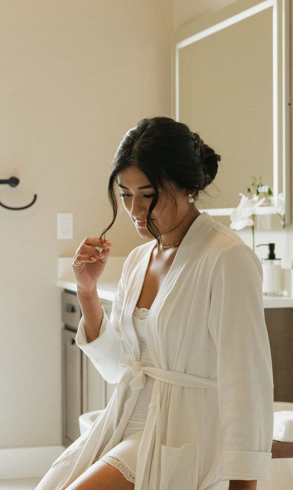 Bride holding her hair while getting ready for her wedding
