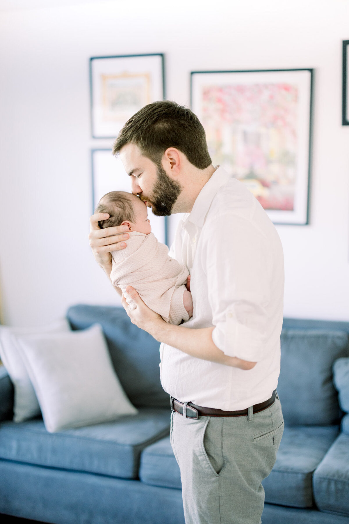 dad kissing baby's head for Tampa newborn photographer Tina Marie Studio.