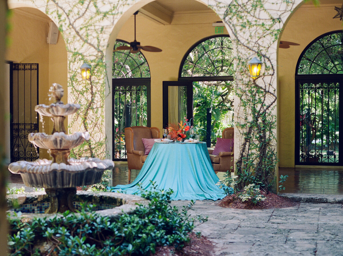 Peep that table in the middle of a courtyard with a fountain.