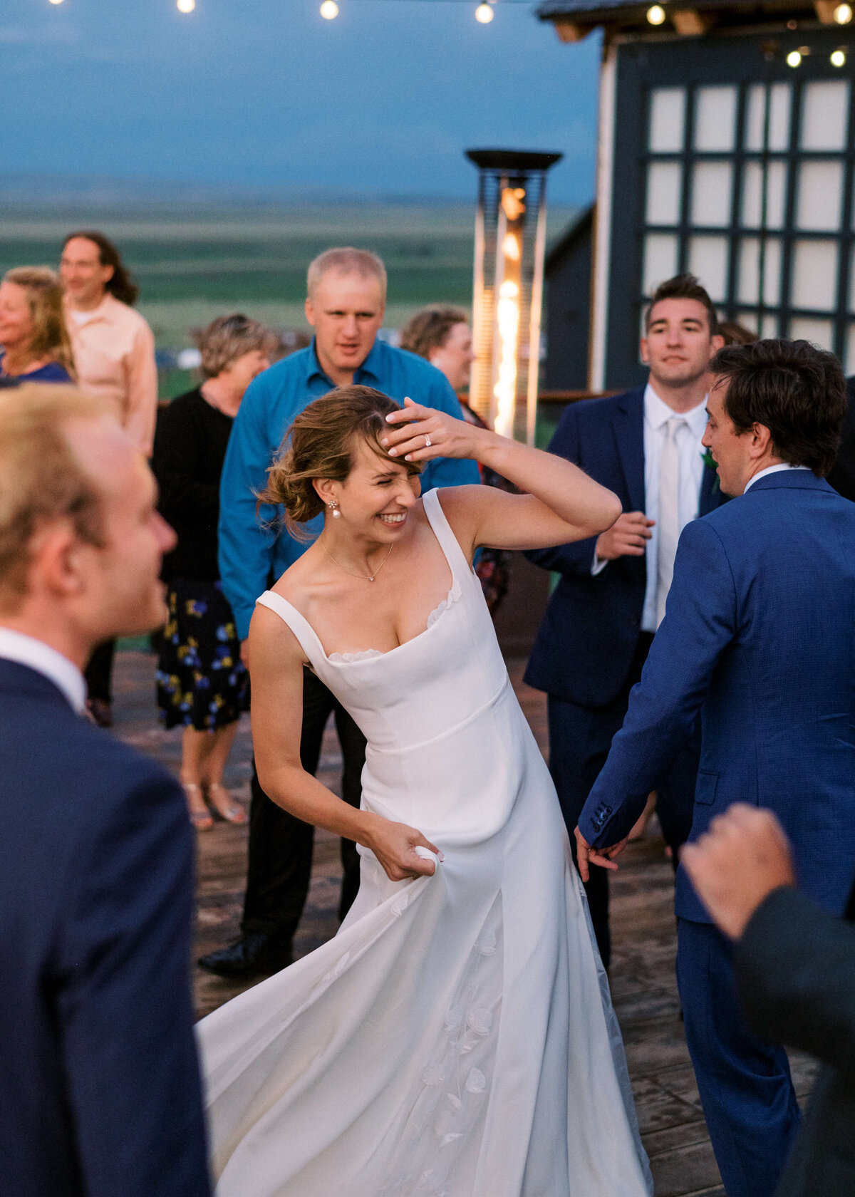 Virginia wedding photographer takes a fun image of a bride dancing with her friends during their outdoor reception