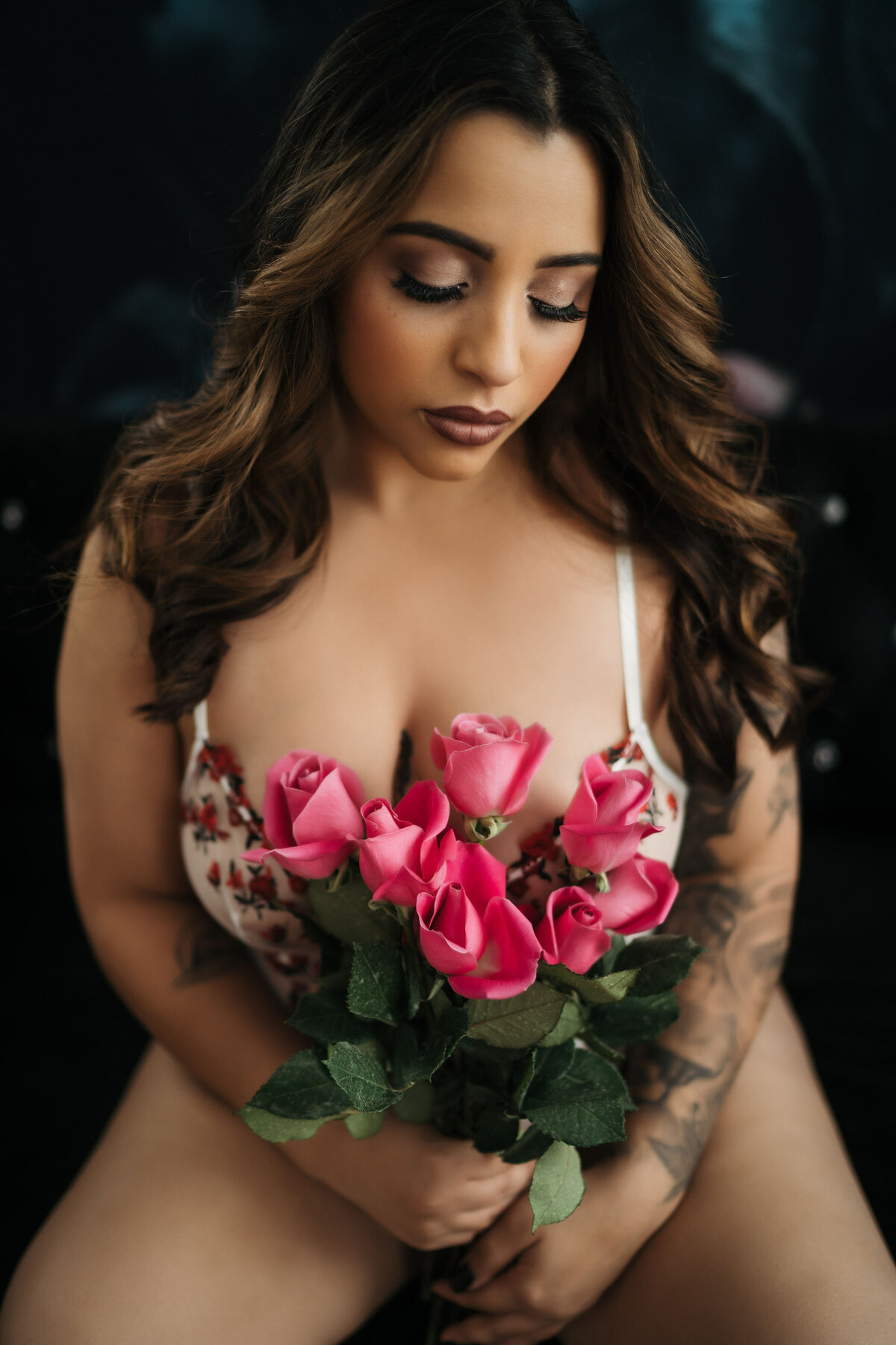 Woman holding pink roses for her Worcester Boudoir Photography session with Kerry Callahan Boudoir