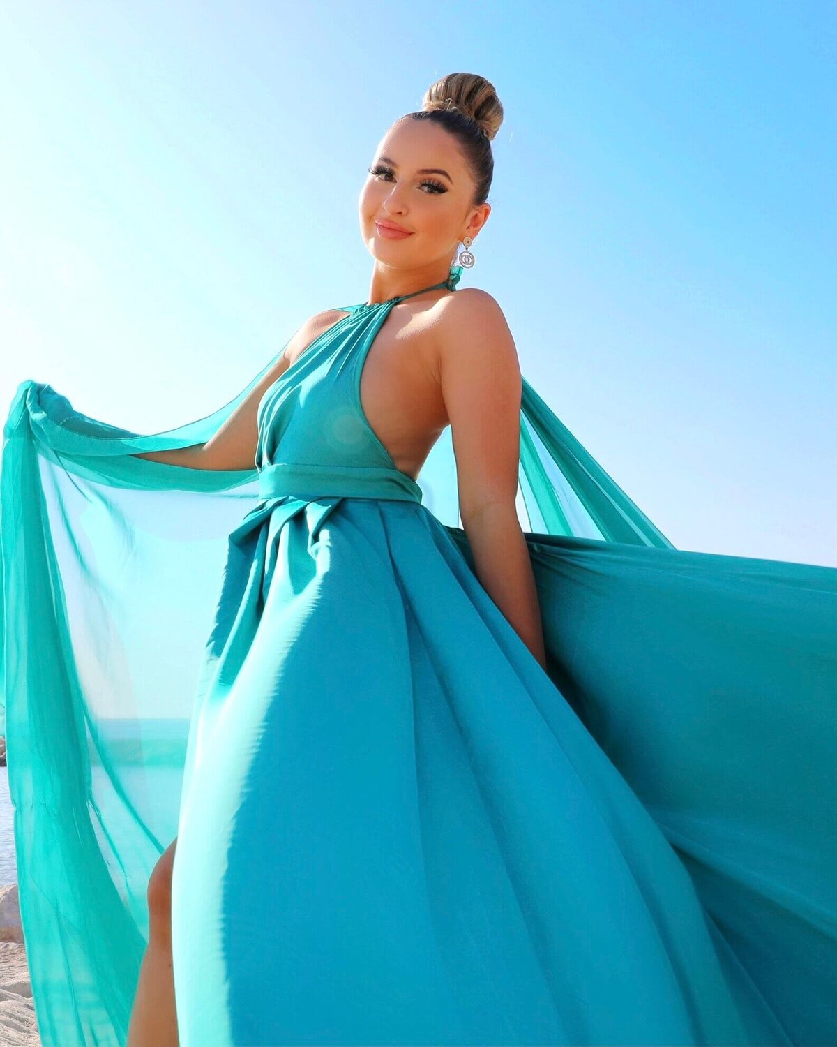 women having a portrait photoshoot in paris wearing a blue flying dress