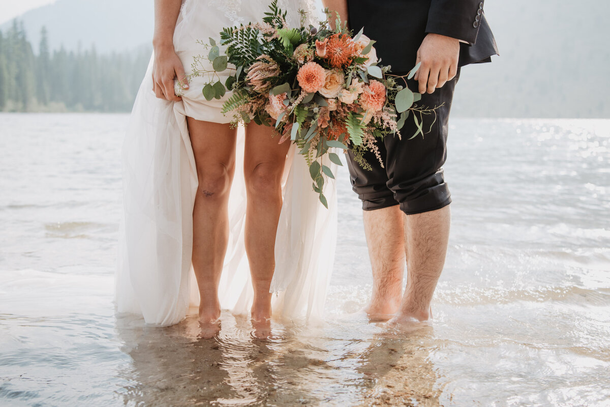 Jackson Hole Photographers capture bride and groom in water after Grand Teton elopement