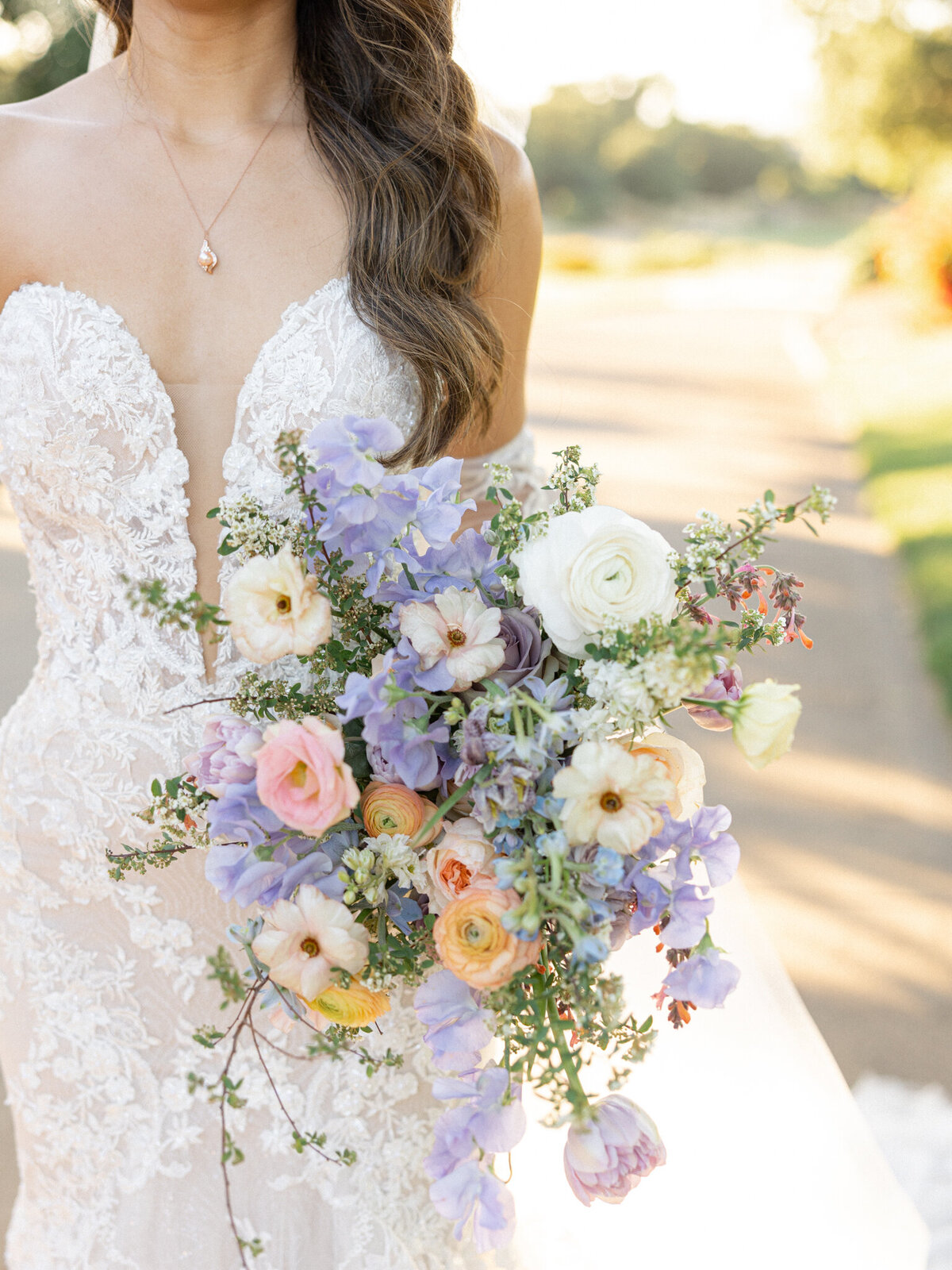 A close-up shot of a bride holding a lush, elegant bouquet on her wedding day, captured by a Napa Valley wedding photographer. The vibrant flowers, thoughtfully arranged with romantic blooms, perfectly complement her bridal look, showcasing the beauty and detail of her special day in wine country.